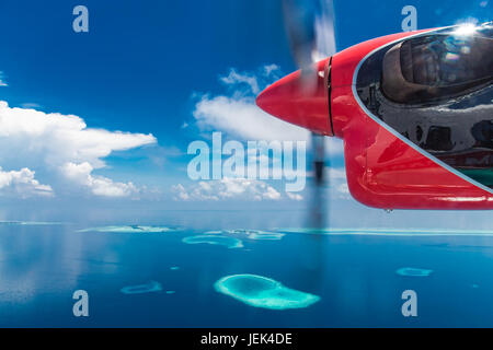 Aerial drone bird's eye view photo of Maldives island and sea. Beautiful turquoise and sapphire clear water beach. Exotic vacation from seaplane view Stock Photo