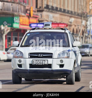 Police car on the road. Police in China are poorly paid and ill trained, traditionally been more involved in maintaining control than solve crimes. Stock Photo