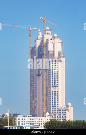 Editorial: ABU DHABI, UNITED ARAB EMIRATES, April 17, 2017 - Side view of the Fairmont Marina Residences building with construction cranes in Abu Dhab Stock Photo