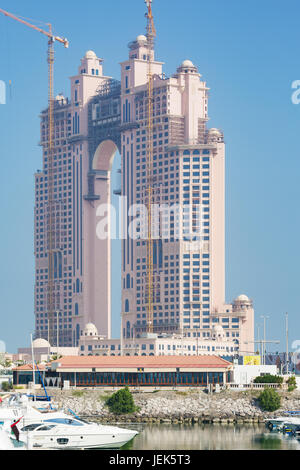 Editorial: ABU DHABI, UNITED ARAB EMIRATES, April 17, 2017 - Frontal view of the Fairmont Marina Residences building with construction cranes in Abu D Stock Photo