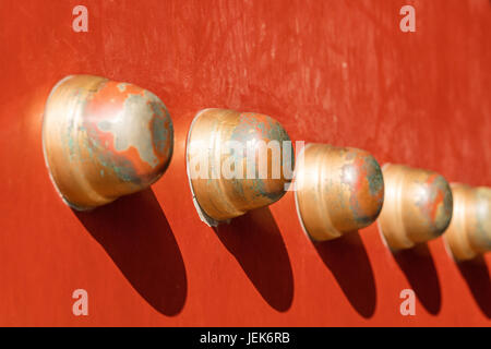Copper knobs on an ancient red wooden door, Beijing, China Stock Photo