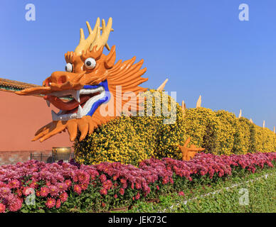 Colorful dragon made of flowers against a blue sky, Beijing, China Stock Photo