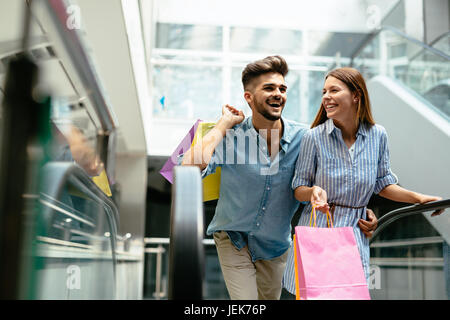 Happy attractive loving couple enjoy spending time in shopping together Stock Photo