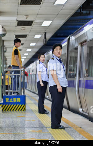 BEIJING-JUNE 9, 2015. Personnel in subway station. Subway rail network serves Beijing urban and suburban districts with 18 lines, 319 stations, 527 KM. Stock Photo