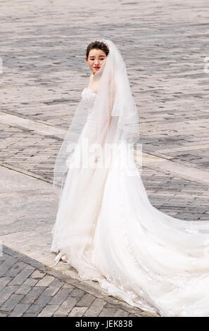 BEIJING-JUNE 9, 2016. Chinese bride poses for photo. Marriage in China has undergone change during reform. Major change is freedom to choose partner. Stock Photo