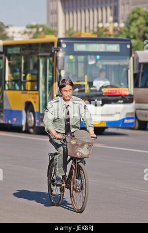 BEIJING-MAY 29, 2013. Security guard on a bicycle. The government announced the average salary in Beijing reached 6,463 yuan per month. Stock Photo