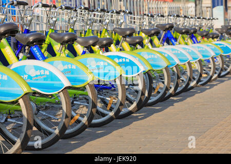 BEIJING-AUG. 27, 2015. Bicycles parked in public bicycle sharing station. Bicycle sharing allow to hire on very short term basis, a popular transport. Stock Photo