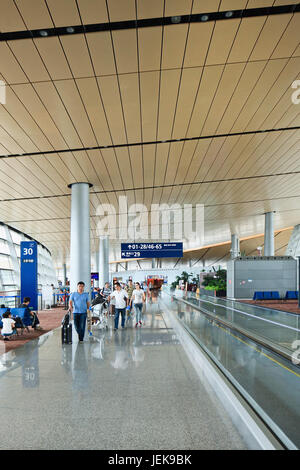 KUNMING-JULY 14, 2014. Spacious interior of Kunming Changshui International Airport with travelers walking around. Stock Photo