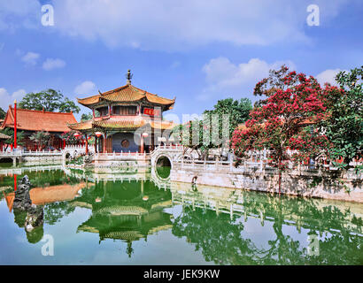 Pavilion mirrored in green pond, Yuantong Temple, Kunming, Yunnan Province, China. Stock Photo