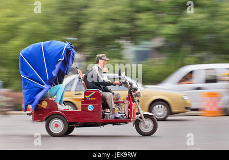NANJING-MAY 24, 2014. Tricycle motor taxi. They are often seen in urban-rural fringe area, where public transportation services are insufficient. Stock Photo