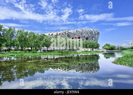 BEIJING-JULY 28. Bird's Nest mirrored in a pond. The Bird's Nest is a stadium in Beijing, China, designed for use throughout the 2008 Summer Olympics. Stock Photo