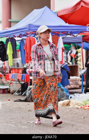 RUILI-CHINA-JUNE 28, 2014. Traditional dressed woman on the street. Ruili is on the border with Myanmar, 64% of population are members of minorities.