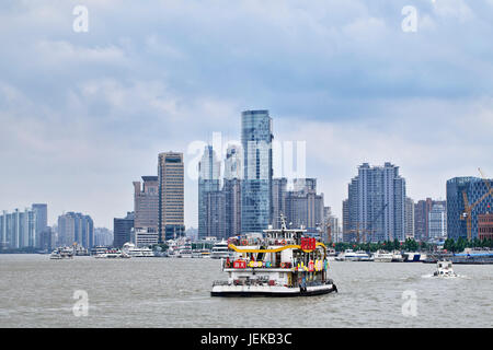 Tour boat on Huangpu River. Shanghai port overtook in 2010 Singapore port to become the world's busiest container port. Stock Photo