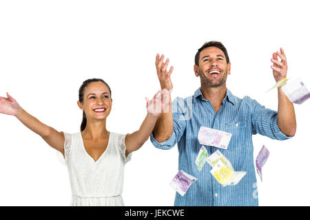 Happy couple throwing money Stock Photo