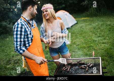 Young beautiful woman and handsome man having barbecue Stock Photo