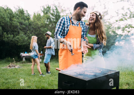 Young beautiful woman and handsome man having barbecue Stock Photo