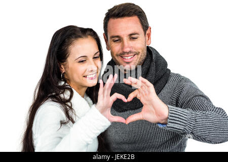 Smiling couple making heart shape with hands Stock Photo