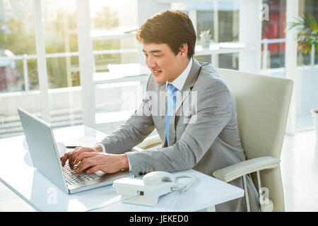 Asian businessman using his computer Stock Photo