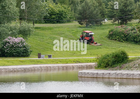 Lawn mowing in the city park, Moscow, Russia. Stock Photo