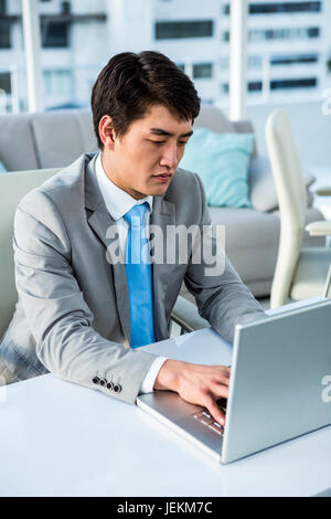 Concentrated businessman typing on computer Stock Photo