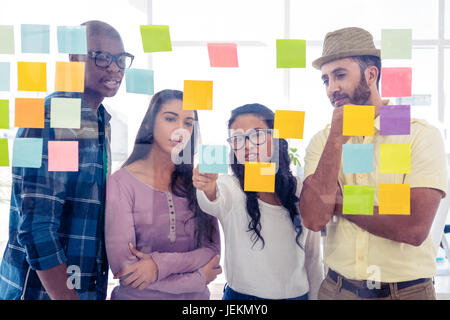 Creative team discussing over adhesive notes Stock Photo