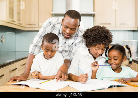 Parents checking children homework Stock Photo