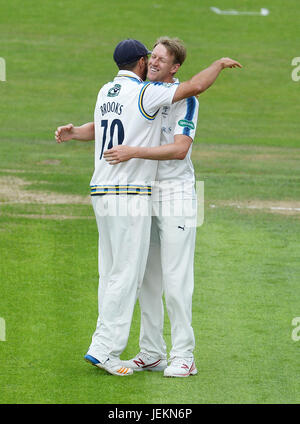 Yorkshire's Steven Patterson (right) celebrates with Jack Brooks after taking the wicket of Surrey's Scott Borthwick during the Specsavers County Championship, Division One match at Headingley, Leeds. Stock Photo