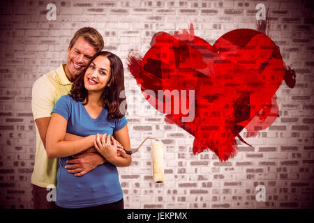 Composite image of happy couple hugging Stock Photo