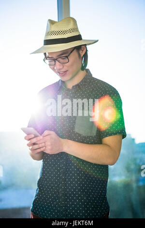 Smiling businessman texting Stock Photo