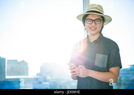 Smiling businessman texting Stock Photo