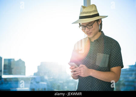 Smiling businessman texting Stock Photo