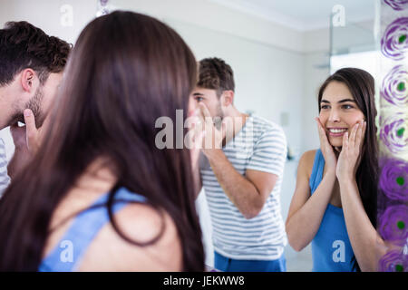 Couple looking themselves in the mirror Stock Photo