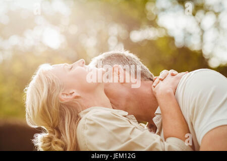 Husband kissing wife on the neck Stock Photo