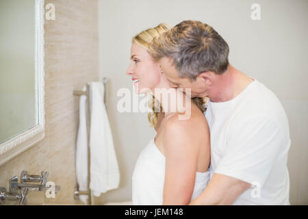 Husband kissing wife on the neck Stock Photo