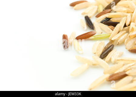 A mixture of three rice types - Basmati, Wild and Red, scattered and isolated on a white background, with copy space in left frame. Stock Photo