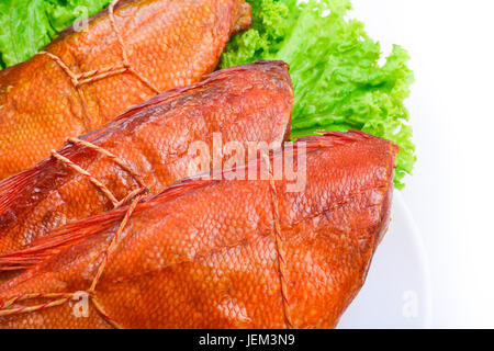 Appetizing smoked fish on a platter Stock Photo