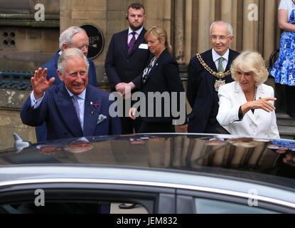 The Prince of Wales and Duchess of Cornwall leave Manchester Town Hall after attending a meeting and reception as part of a visit to Manchester. Stock Photo