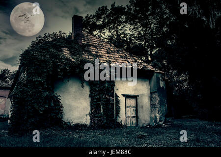 Abandoned ghost house at night Stock Photo