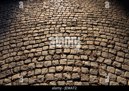 Gloomy old cobblestone pavement. Beautiful stone background Stock Photo