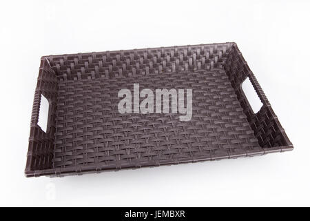 Empty brown plastic tray on a white surface. Plastic tray isolated on white background. Stock Photo