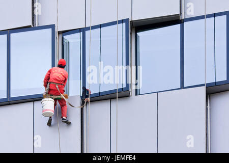 BEIJING - APRIL 28, 2009. Window cleaners at work. They are known as spider-men because they entrust their lives to a single thread, made of hemp. Stock Photo
