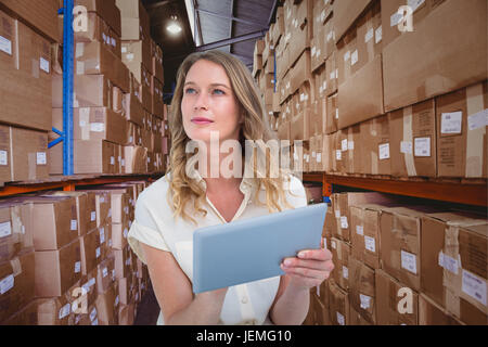 Composite image of woman using tablet pc Stock Photo