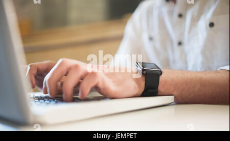 Cropped image of male student using laptop Stock Photo