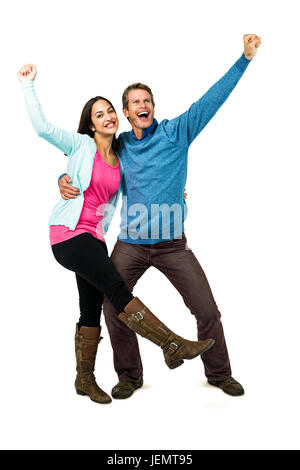 Happy successful couple with hands raised Stock Photo