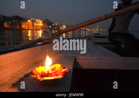 Lit Candle on a Boat at Night in The Ganges River in Varanasi, India Stock Photo