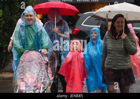 South Kensington, London, UK. 27th Jun, 2017. Rain showers across, United Kingdom. 27th June, 2017. Picture shows people covering up avoiding the heavy rain showers as the weathwer breaks after the high temperatures and recent fine weather in the capital London., England UK Credit: Clickpics/Alamy Live News Stock Photo