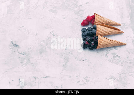 Raspberries, blackberries and blueberries in waffle cones Stock Photo