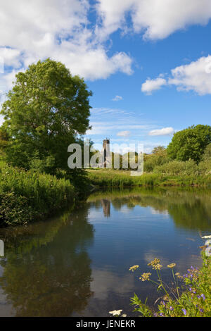 a medieval village pond and st martins church ruin at the historical site of wharram percy in the yorkshire wolds under a blue sky in summer Stock Photo