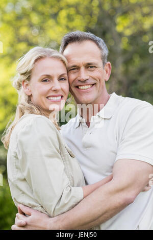 Cute couple hugging with arms around Stock Photo