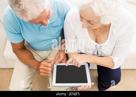 Focused senior couple using tablet Stock Photo